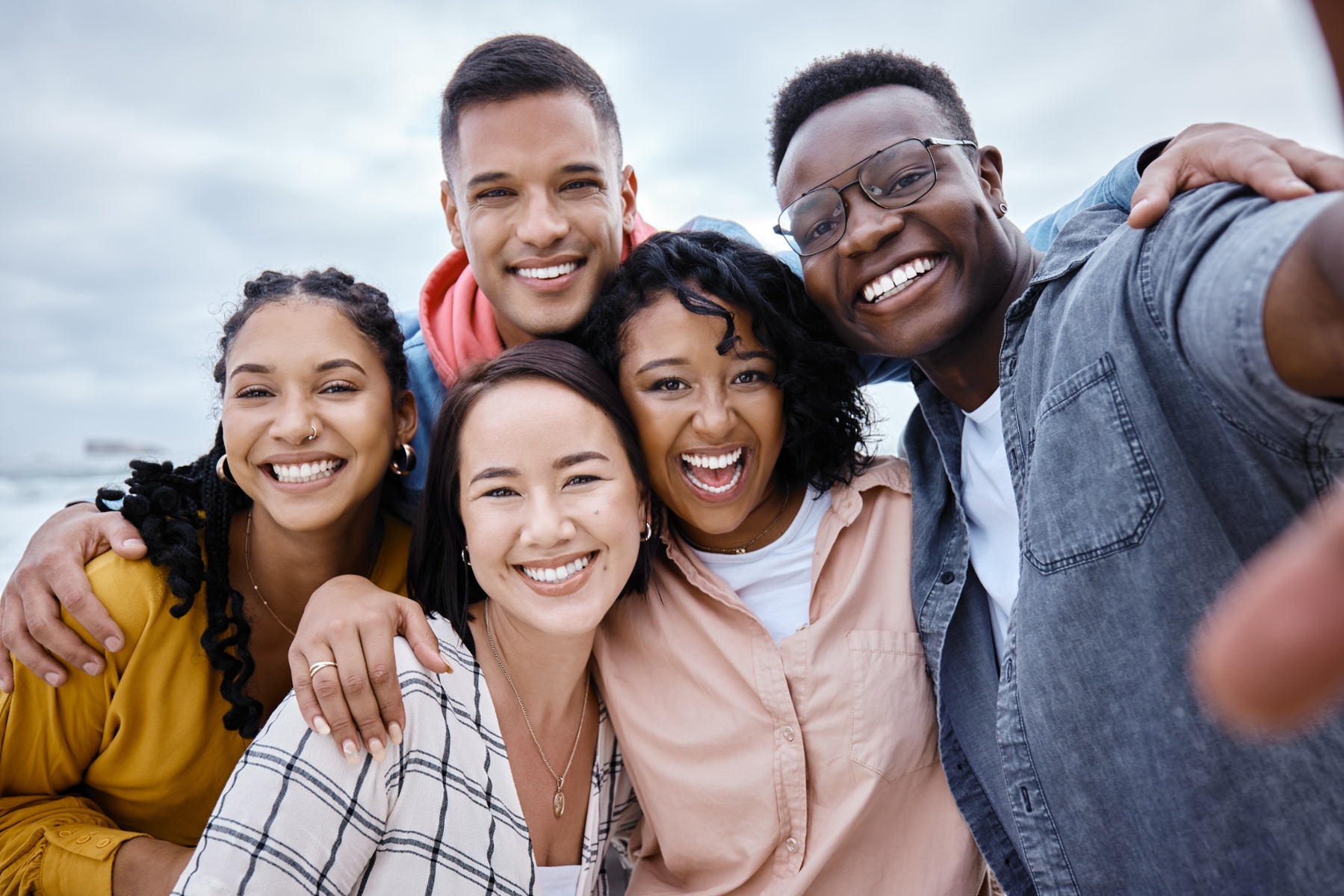 Group of friends smiling together outside