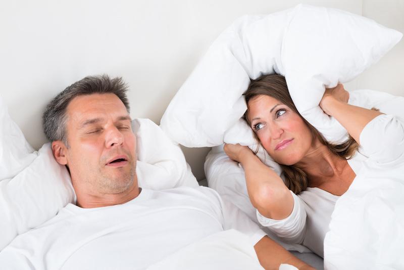 Woman holding pillows over her ears, fort collins co