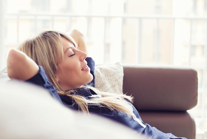 Blonde woman smiling on a couch, fort collins co