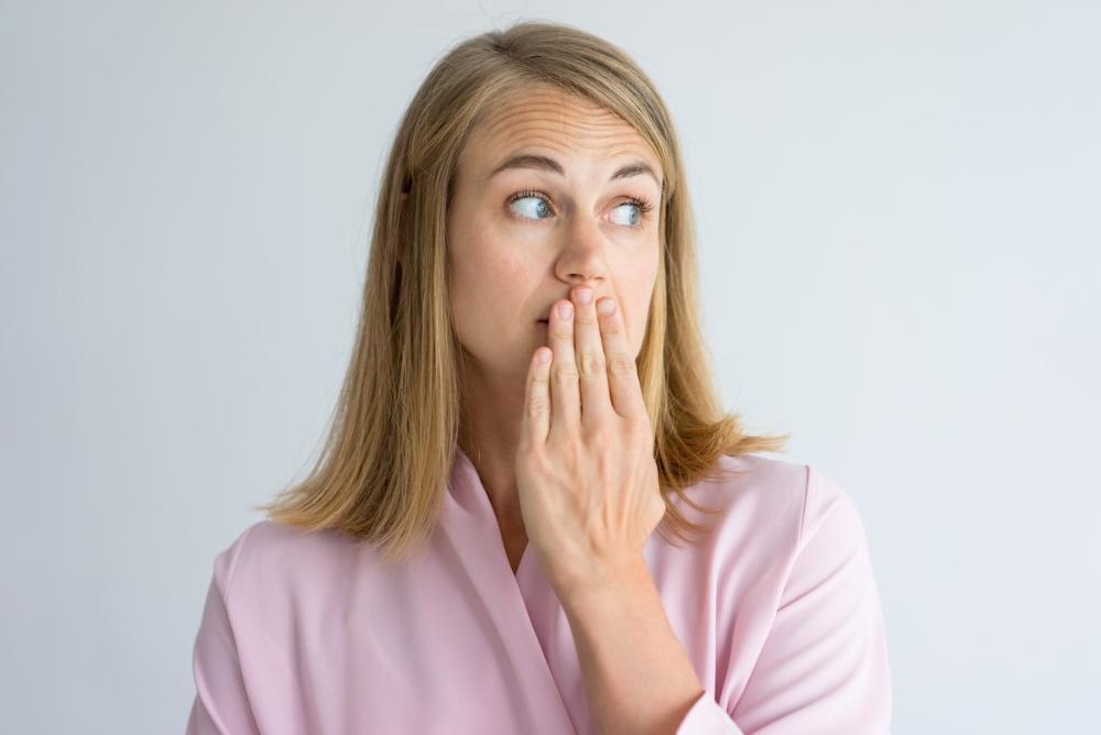 Woman covering her mouth, fort collins co