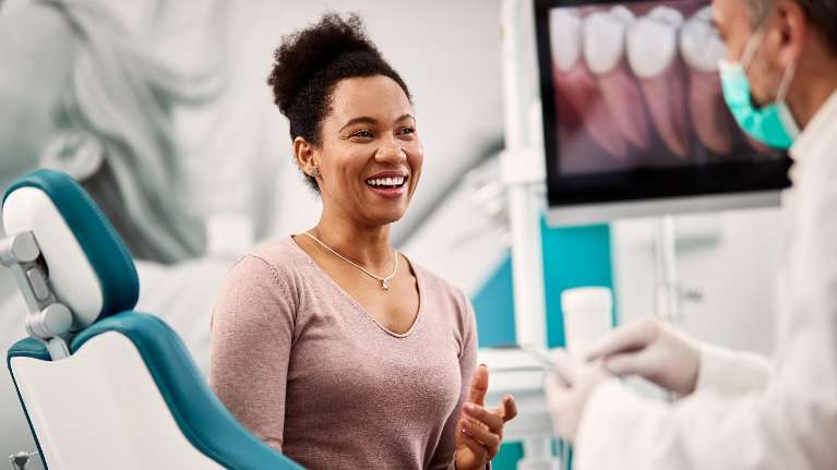 woman smiling during dentist visit