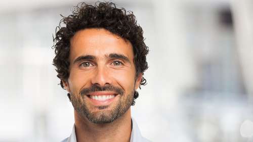 Man with brown curly hair smiling, fort collins co