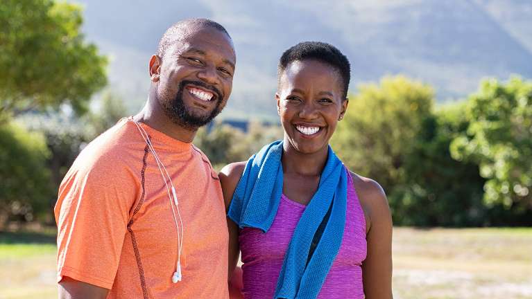 A couple smiling in front of a mountain | dentist Fort Collins