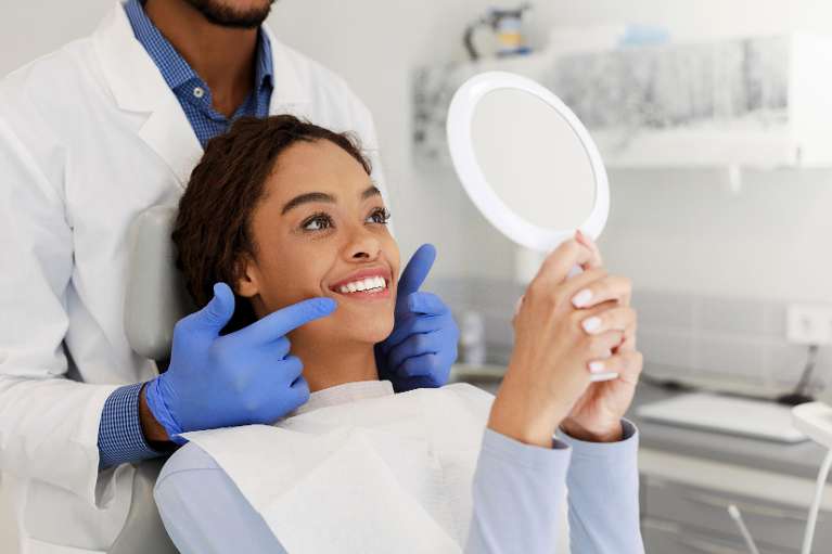 patient and dentist discussing tooth replacement options in fort collins