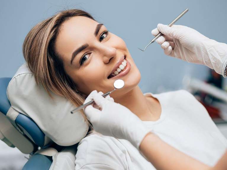 Young woman in dental chair about to get a tooth-colored filling, fort collins co