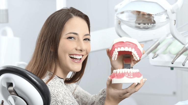 Woman holding a fake mouth smiling, fort collins colorado