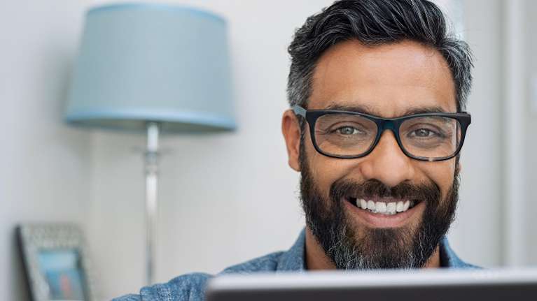A man smiling in his office | dentist in fort collins