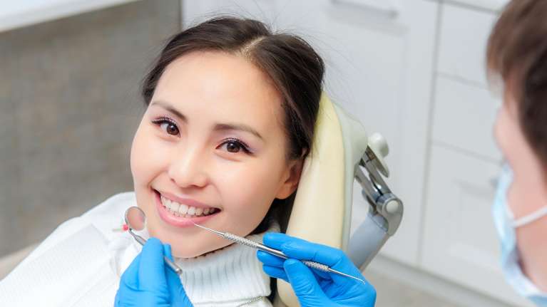 A woman getting a dental cleaning fort collins