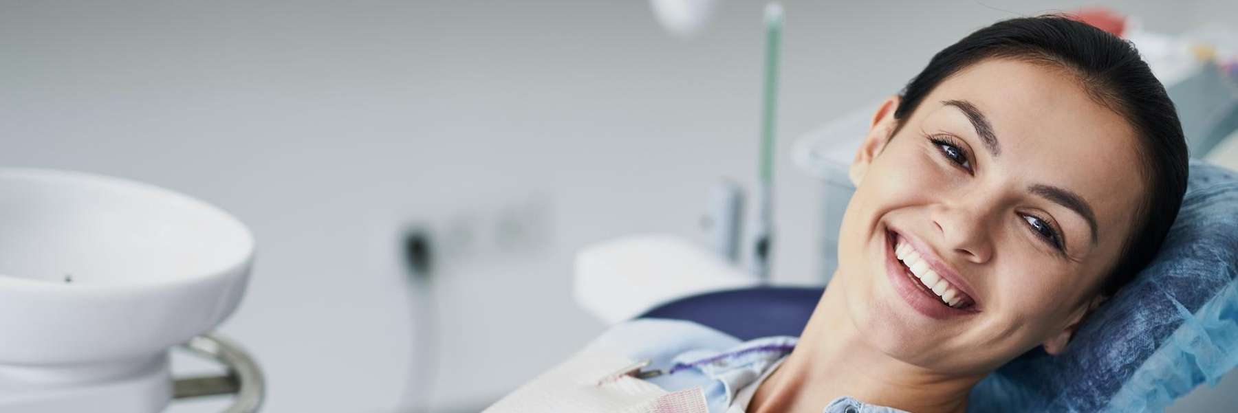Woman smiling in dental chair, fort collins co