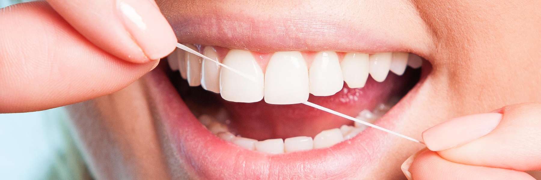 A person flossing | dentist fort collins