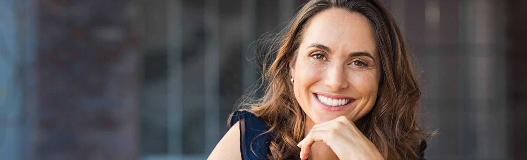 woman smiling after dental services, Fort Collins CO